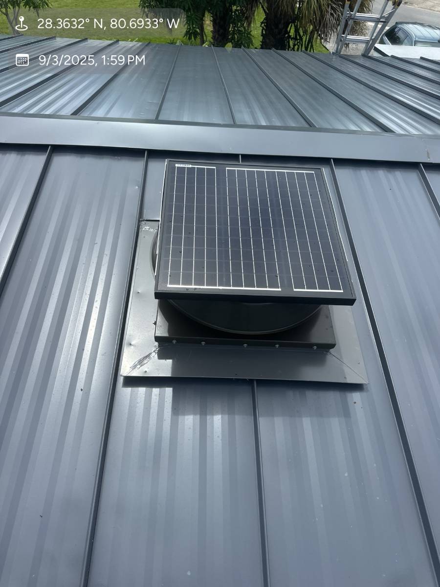 Dark gray standing seam metal roof with solar attic fan installed by Hippo Roofing in Rockledge, FL