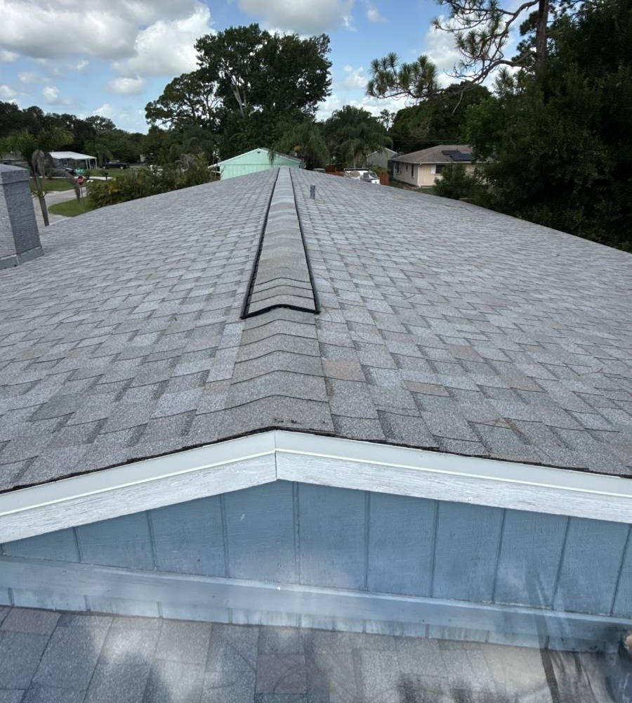 Gray architectural shingle roof with ridge vent by Hippo Roofing in Sebastian, FL